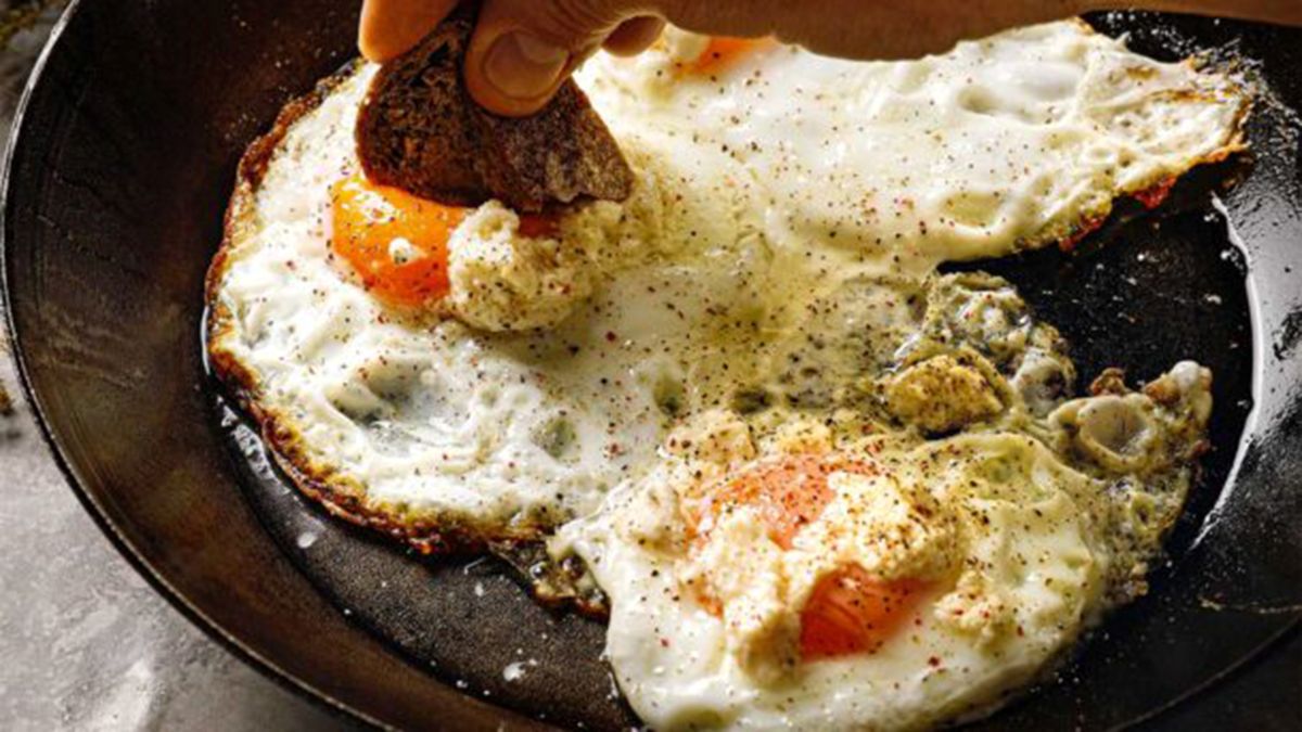 Τηγανητά αυγά με μελάτο κρόκο σε τηγάνι με λιωμένο βούτυρο και ελαιόλαδο