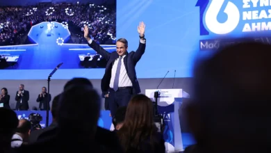 Στιγμιότυπο από κομματική εκδήλωση της Νέας Δημοκρατίας με φόντο το λογότυπο